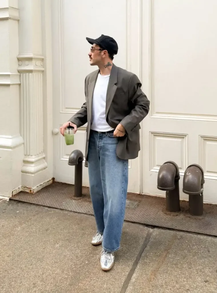 16 Fall Outfits With Jeans for Men You Can Actually Wear 3 a man posing in a Relaxed Blue Jeans with an Oversized Blazer