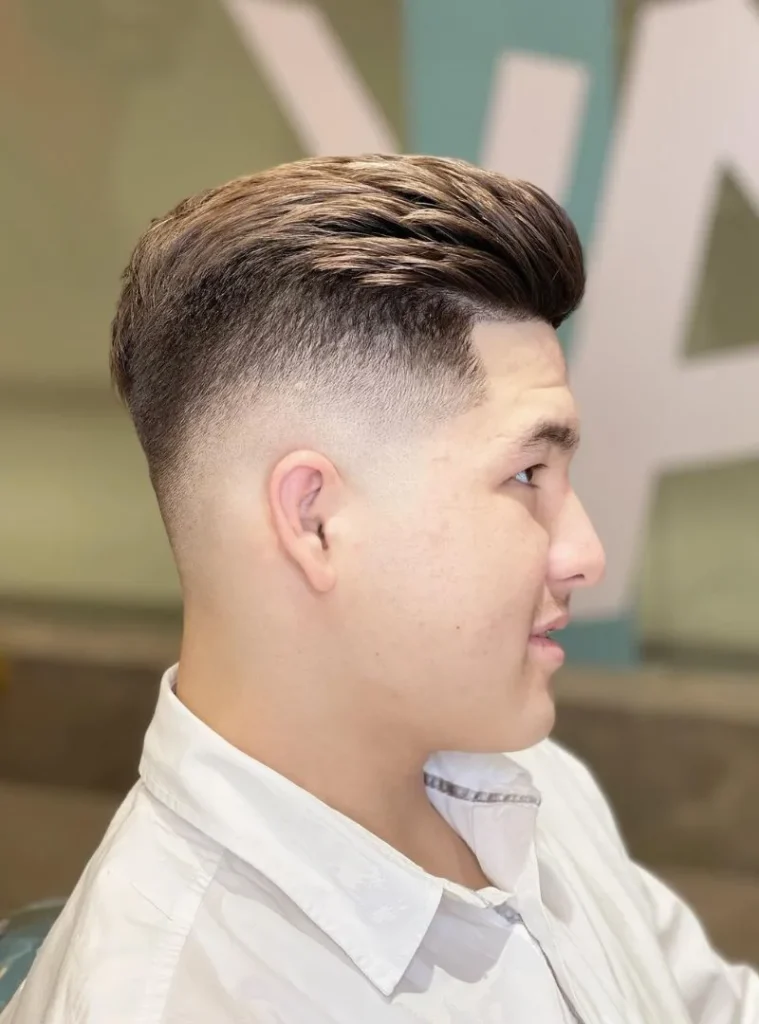 19 Skin Fade Hair Styles Men Can Try for a Clean, Modern Cut 3 a High Skin Fade haircut of a man With Brushed-Back Volume