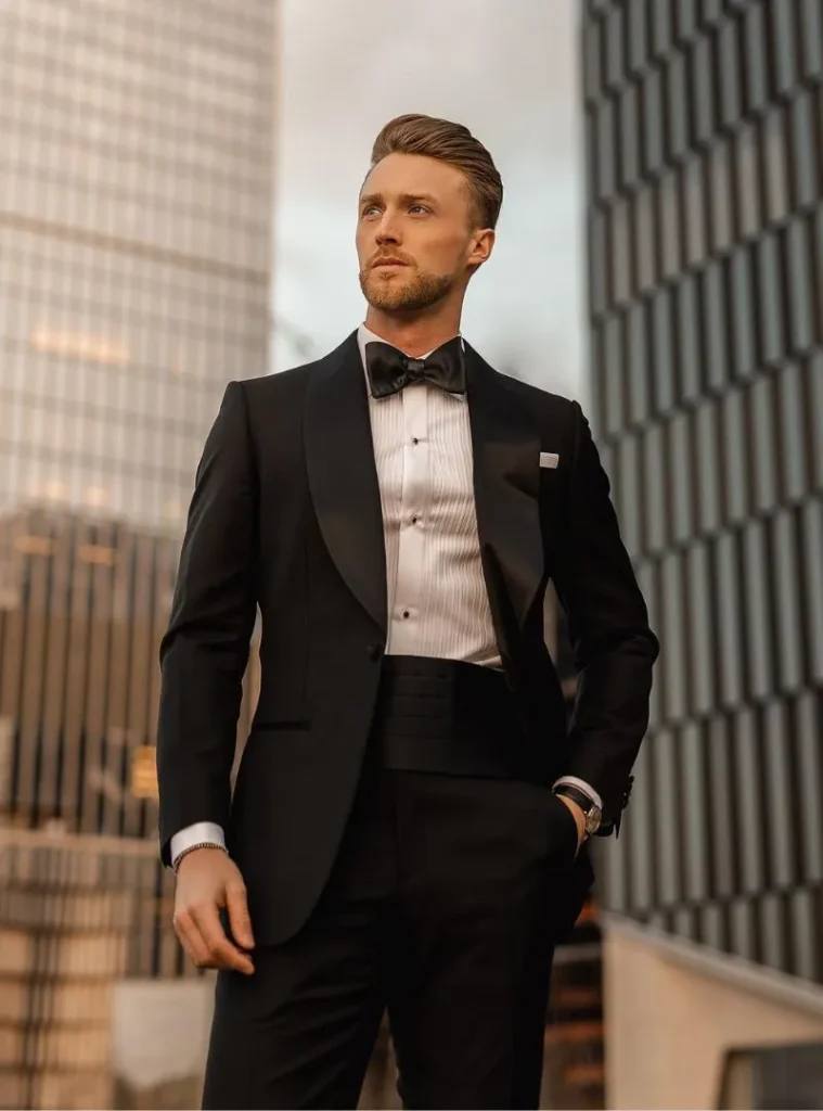 17 Winter Formal Outfits for Men That Look Sharp 4 a man wearing a Classic Black Tuxedo with a Pleated White Shirt