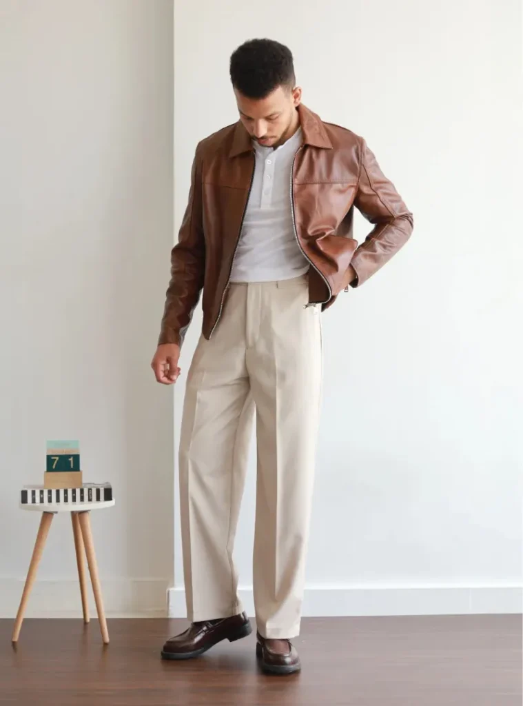 20 Easy Ideas for Fall Casual Outfits Men Can Rely On 19 a man posing in a Brown Leather Zip Jacket with Cream Dress Pants