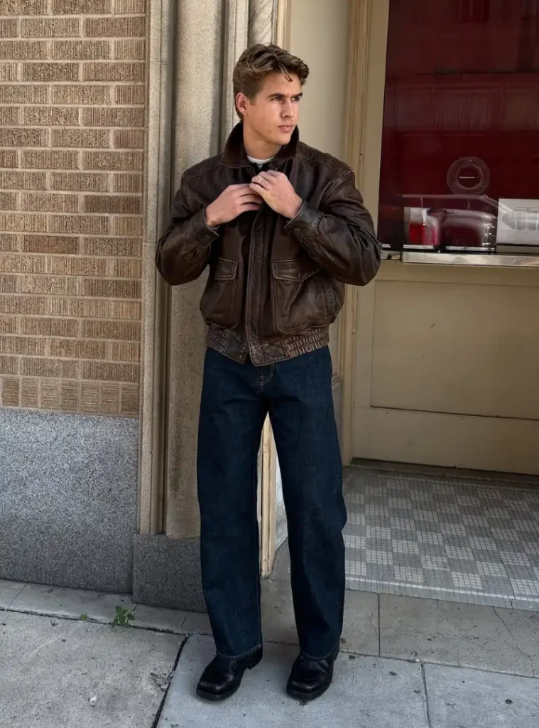 20 Easy Ideas for Fall Casual Outfits Men Can Rely On 18 a man wearing a Vintage Leather Bomber Jacket with Dark Denim