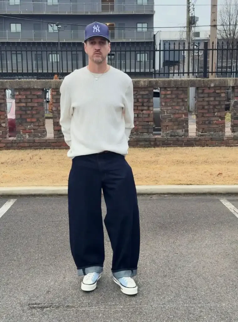 16 Fall Outfits With Jeans for Men You Can Actually Wear 5 a man in a Dark Wide-Leg Jeans with a Clean White Sweater