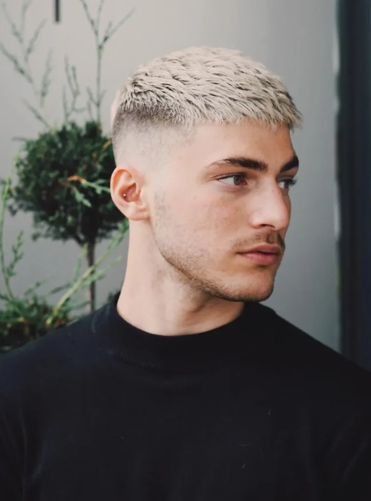 19 Skin Fade Hair Styles Men Can Try for a Clean, Modern Cut 9 a man in a Bleached Textured Crop with a High Skin Fade