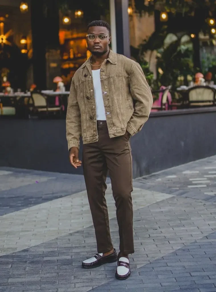22 Fall Jackets Outfit Ideas for Men to Layer Up in Style 9 a man wearing a A Tan Denim Jacket Styled with Brown Trousers