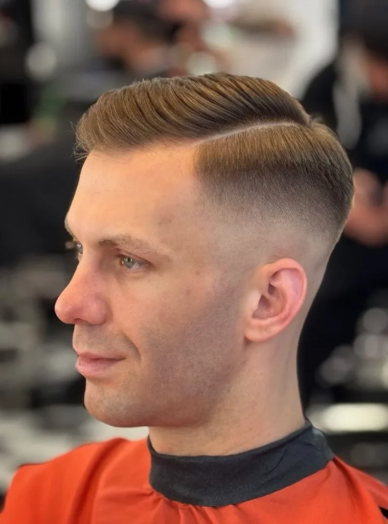 19 Skin Fade Hair Styles Men Can Try for a Clean, Modern Cut 2 A man with a Skin Fade With a Clean Side Part