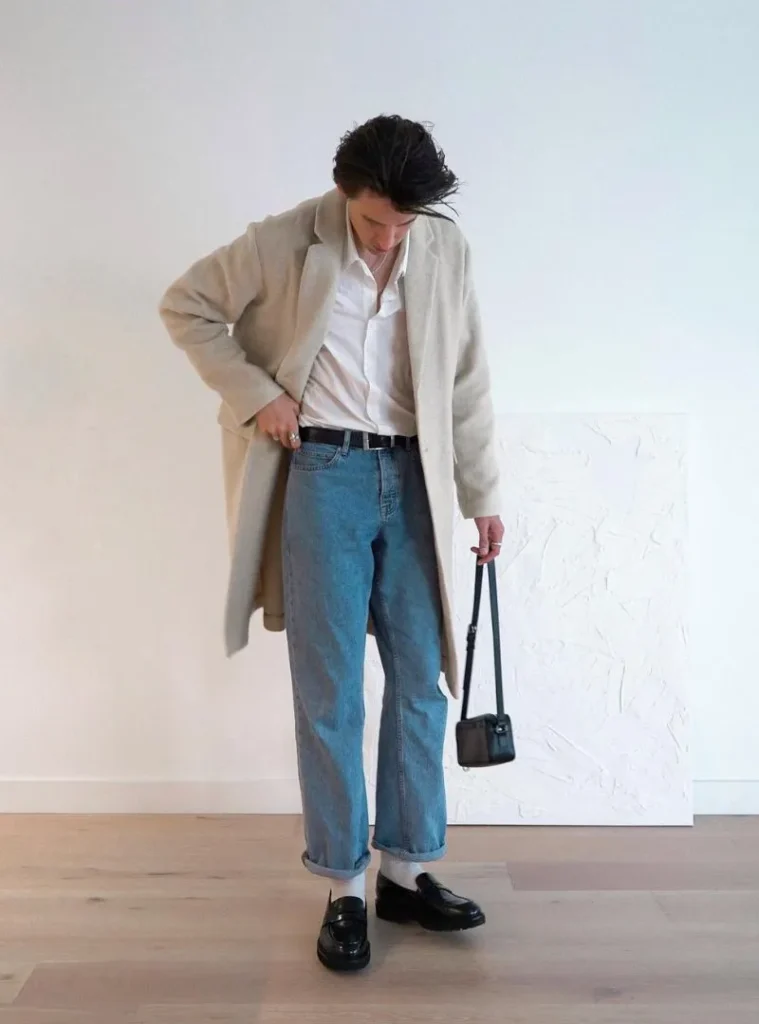 16 Fall Outfits With Jeans for Men You Can Actually Wear 9 a man wearing a Light Blue Jeans with a Cream Coat