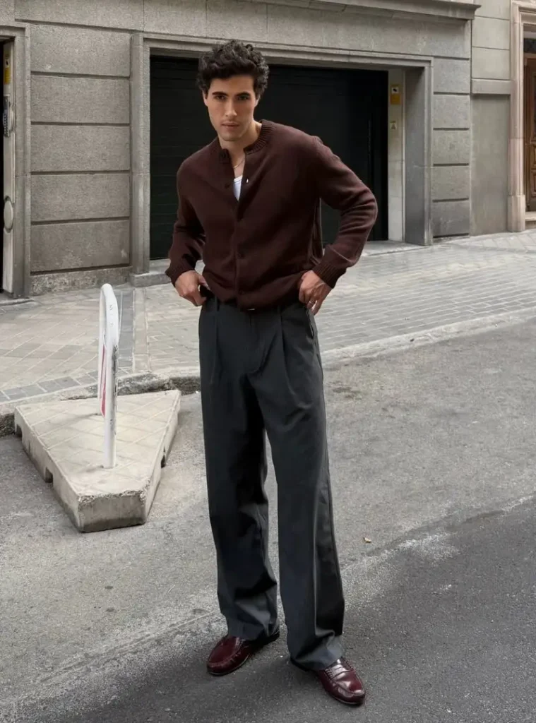 17 Easy Men Fall Outfit Ideas That Keep You Warm 18 a man posing in a Buttoned Espresso Crew Cardigan with Wide Slate Trousers