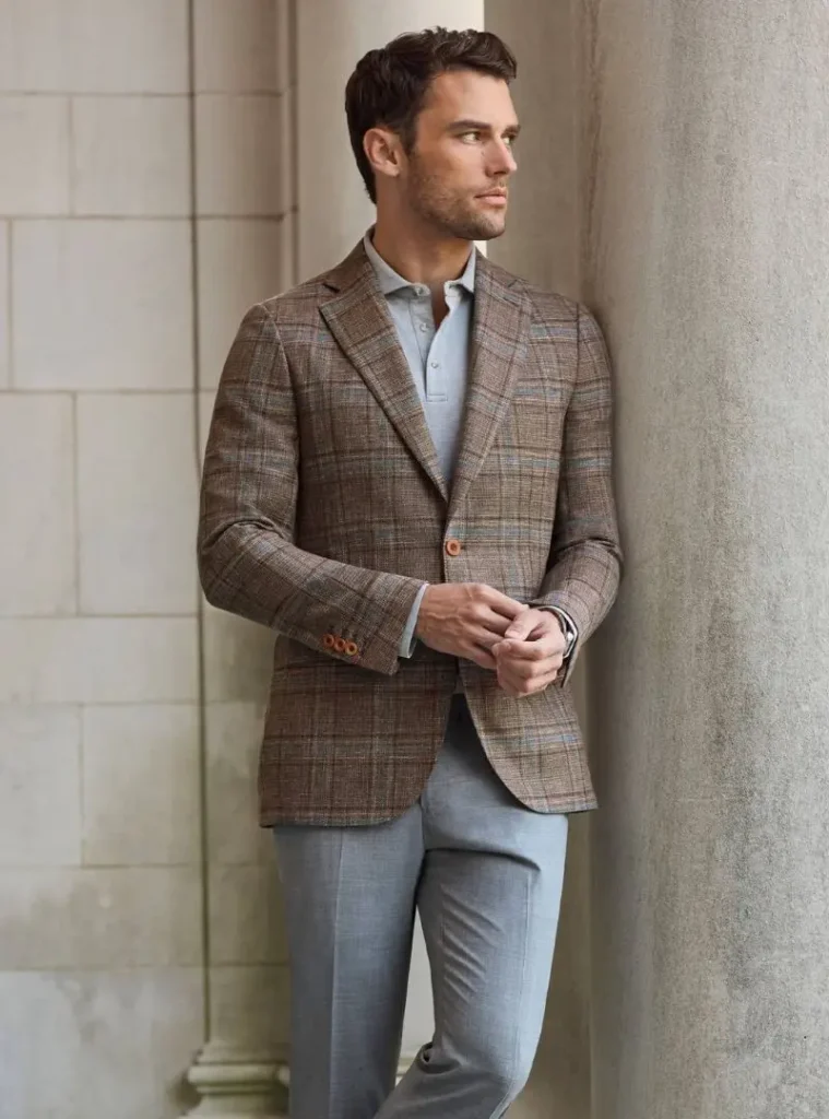 12 Smart Fall Business Casual Outfit Ideas to Look Sharp 5 a man posing in a Glen Plaid Wool Sport Coat with Knit Polo and Slacks
