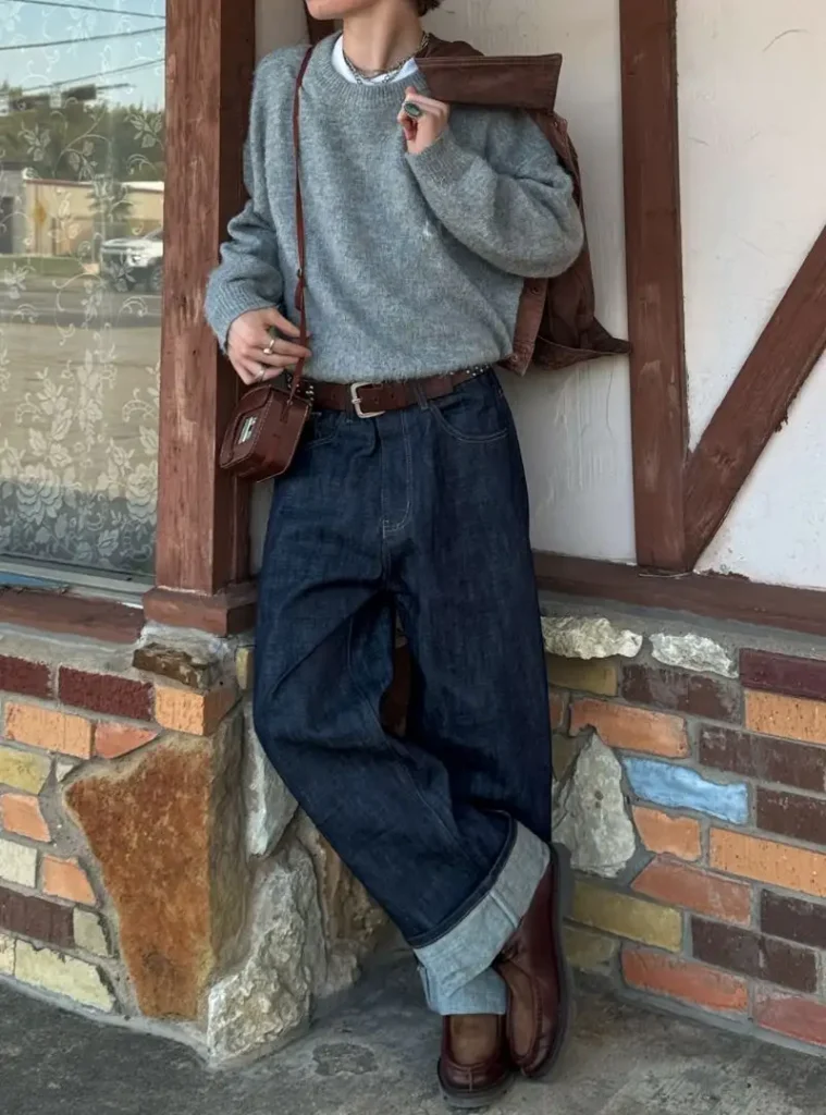 16 Fall Outfits With Jeans for Men You Can Actually Wear 10 a man wearing a Dark Cuffed Jeans with a Grey Knit and Brown Leather Details