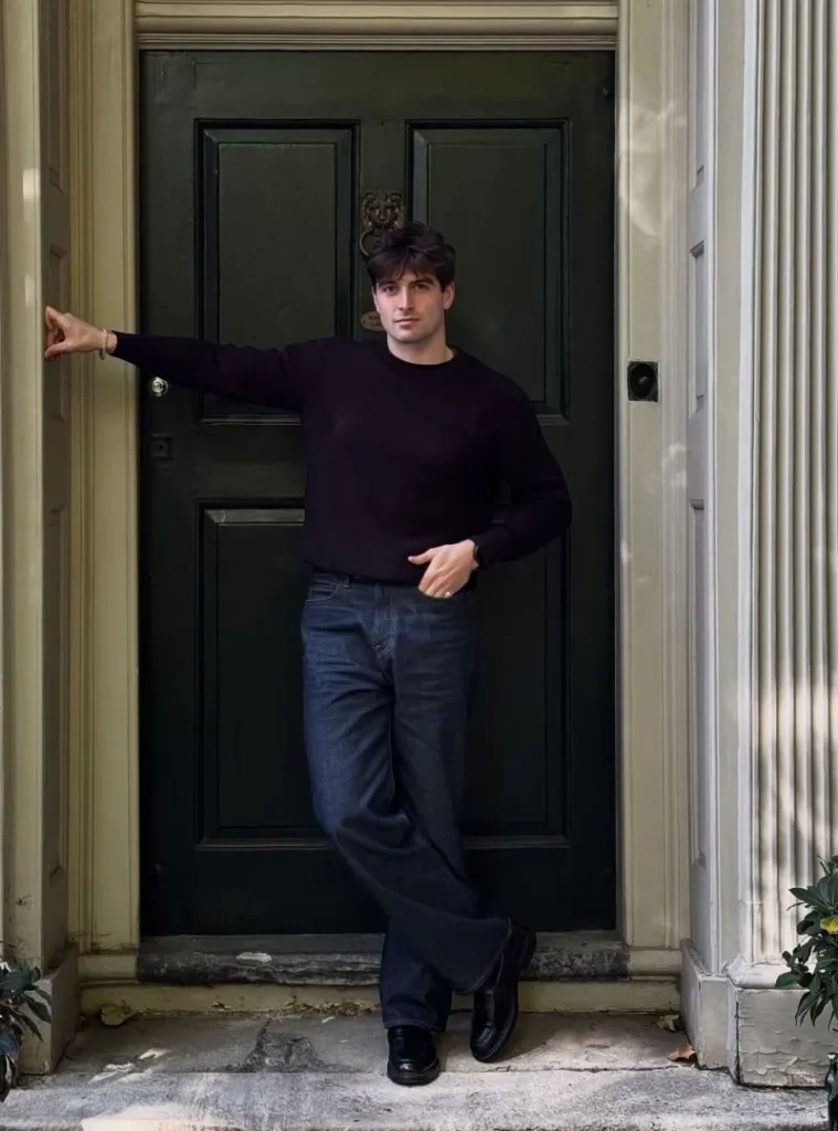 17 Easy Men Fall Outfit Ideas That Keep You Warm 11 a man posing for a picture with a Fine Gauge Black Knit Tucked into Dark Wash Denim