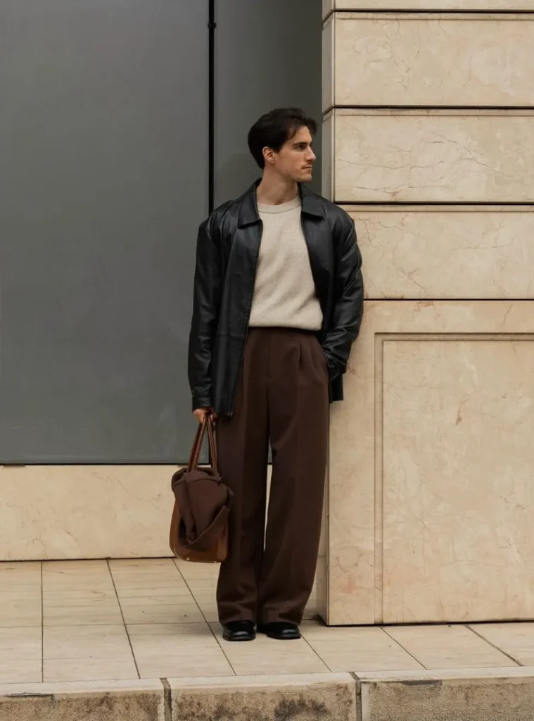 12 Smart Fall Business Casual Outfit Ideas to Look Sharp 8 a man posing in a Black Leather Car Coat with Oatmeal Knit and Mocha Slacks