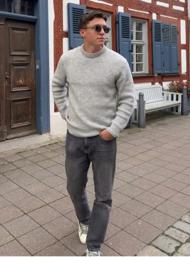 17 Easy Men Fall Outfit Ideas That Keep You Warm 10 a man wearing a Thick Grey Ribbed Crewneck with Faded Slim Jeans