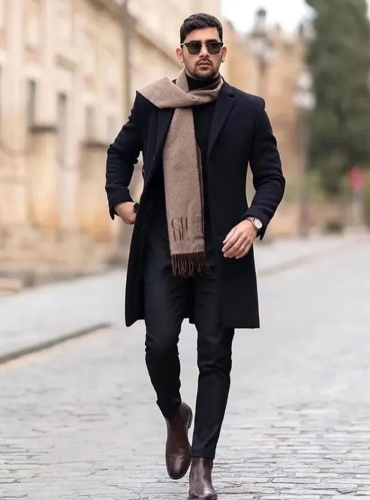 14 Men Casual Winter Outfits Ideas for Everyday Style 11 a man wearing Tailored Black Topcoat with a Draped Camel Scarf