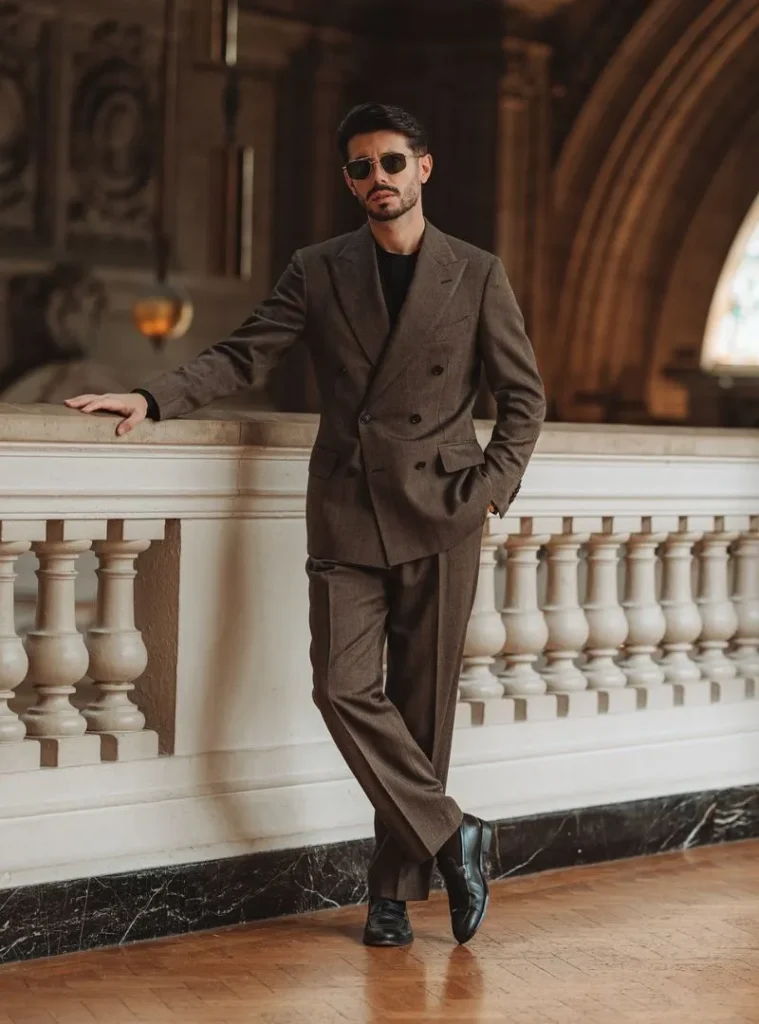 17 Winter Formal Outfits for Men That Look Sharp 12 a man posing in a Brown Double-Breasted Suit Over a Black Knit