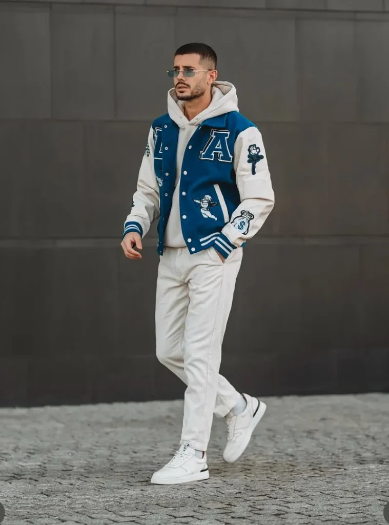14 Men Casual Winter Outfits Ideas for Everyday Style 12 a man wearing Colorblocked Varsity Jacket Over Off-White Corduroy