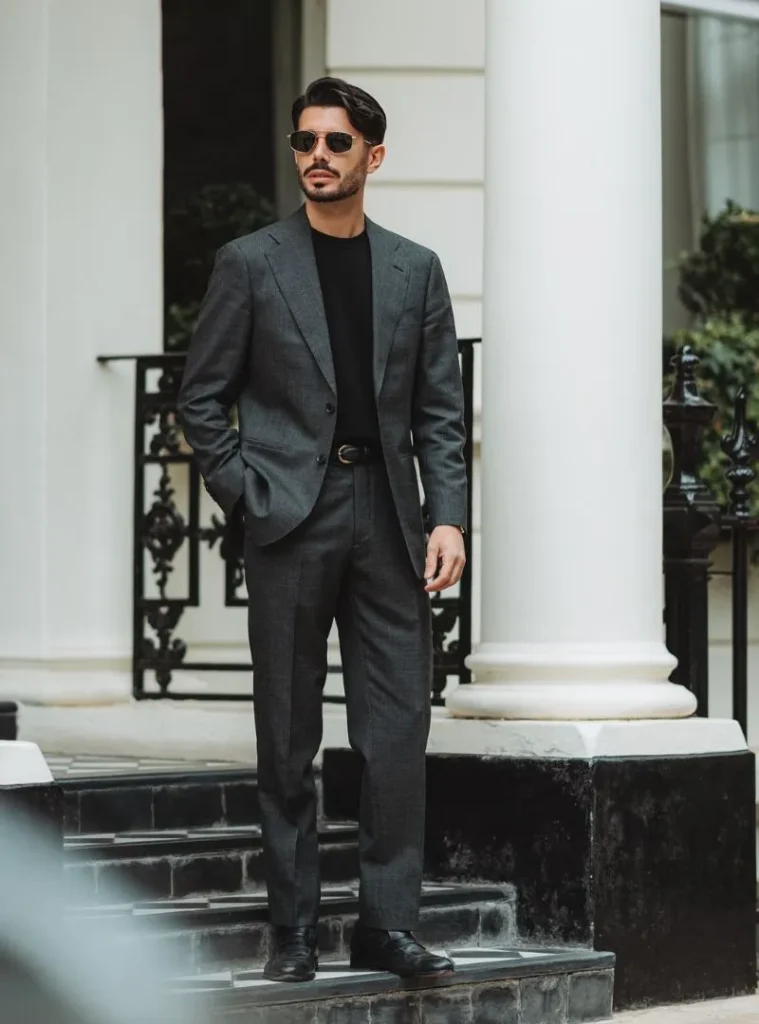 17 Winter Formal Outfits for Men That Look Sharp 14 a man wearing a Charcoal Suit with a Black Crewneck Knit
