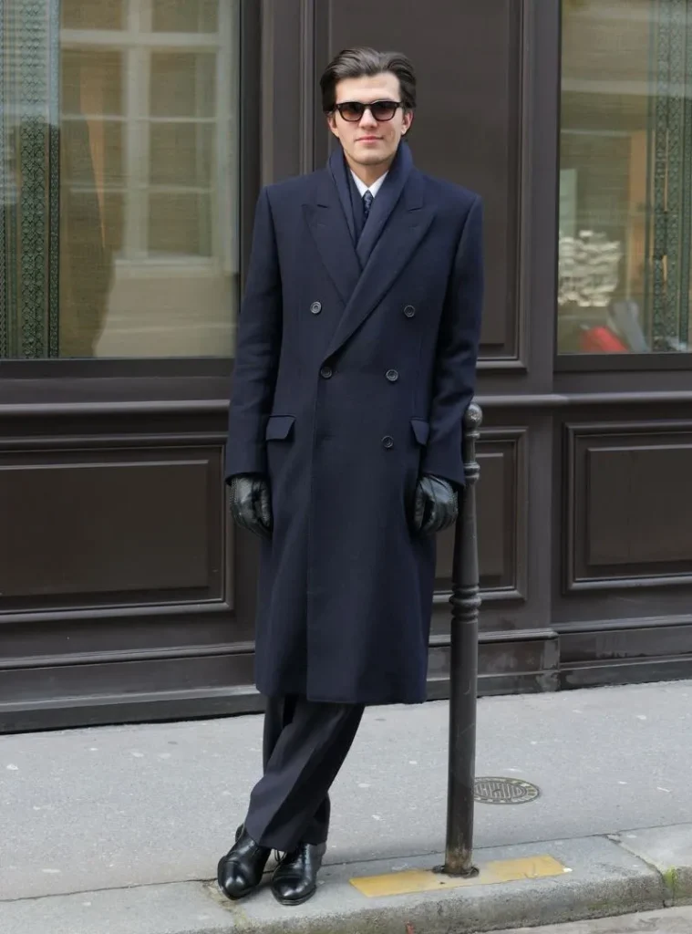 17 Winter Formal Outfits for Men That Look Sharp 16 a man posing in a Navy Double-Breasted Overcoat with Scarf and Leather Gloves