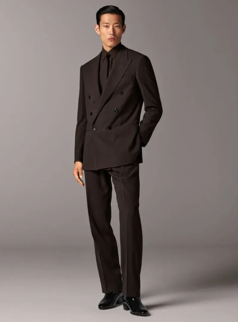 17 Winter Formal Outfits for Men That Look Sharp 18 a man posing in a Dark Brown Double-Breasted Suit with a Black Shirt and Tie