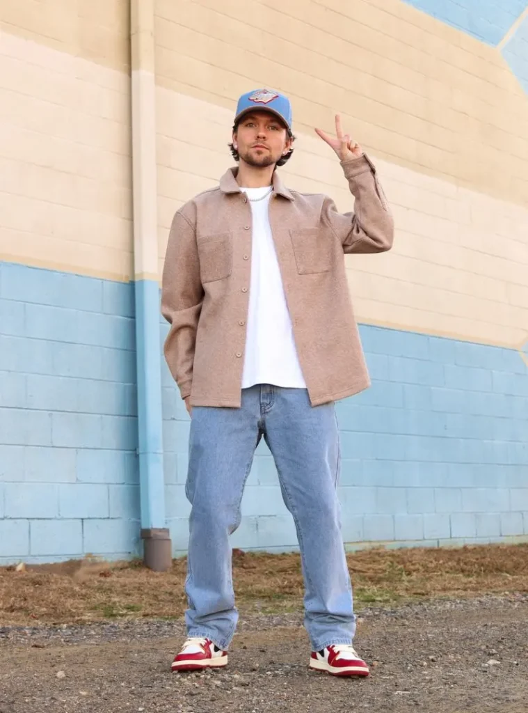 17 Easy Men Fall Outfit Ideas That Keep You Warm 6 a man posing in a Camel Wool Overshirt with Mid-Wash Straight Denim