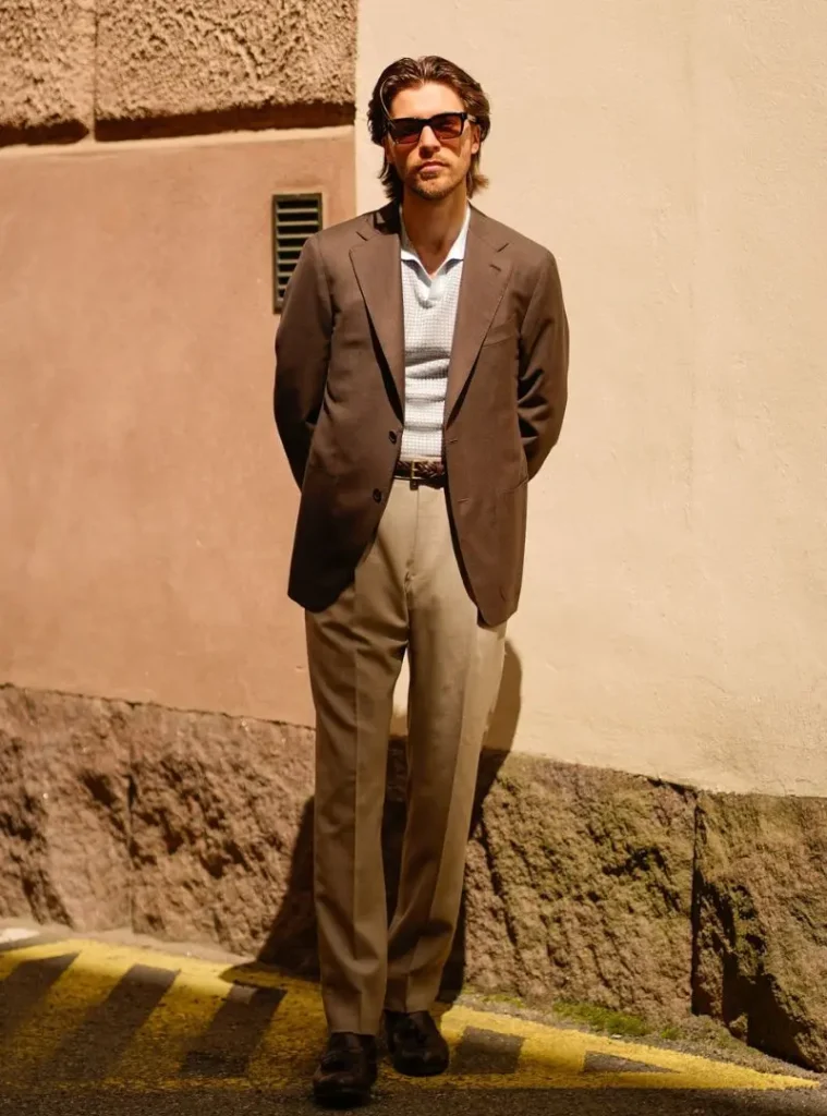 12 Smart Fall Business Casual Outfit Ideas to Look Sharp 12 a man posing in a Earthy Tailored Blazer with a Patterned Knit Polo