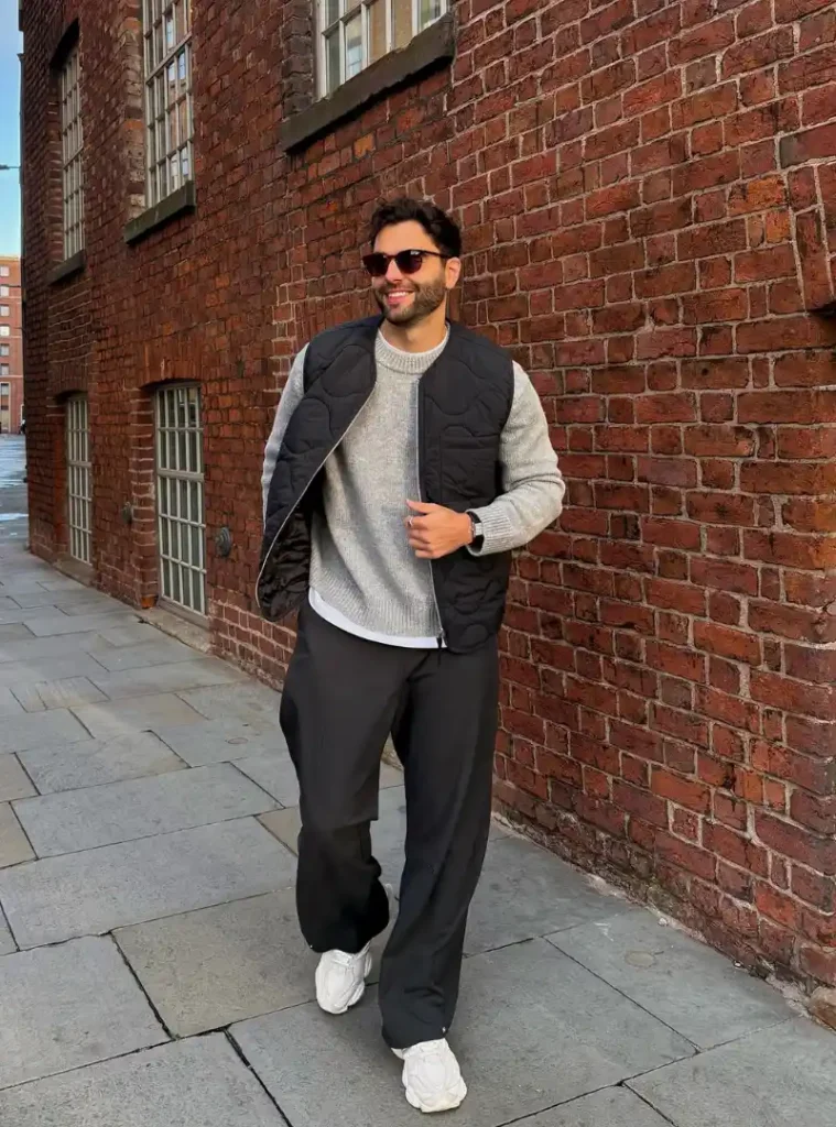20 Easy Ideas for Fall Casual Outfits Men Can Rely On 9 a man wearing a Quilted Black Vest Over a Grey Crewneck