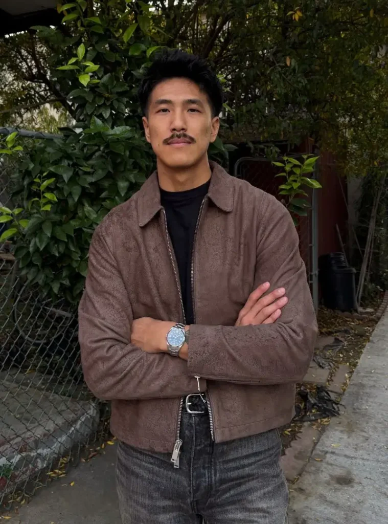 22 Fall Jackets Outfit Ideas for Men to Layer Up in Style 23 a man posing in a Minimalist Taupe Suede Zip Jacket with Washed Denim